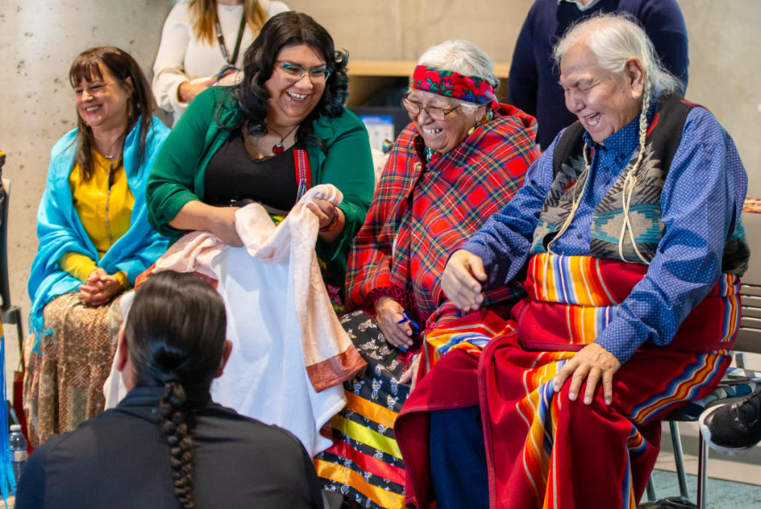 Indigenous elders sit in conversation