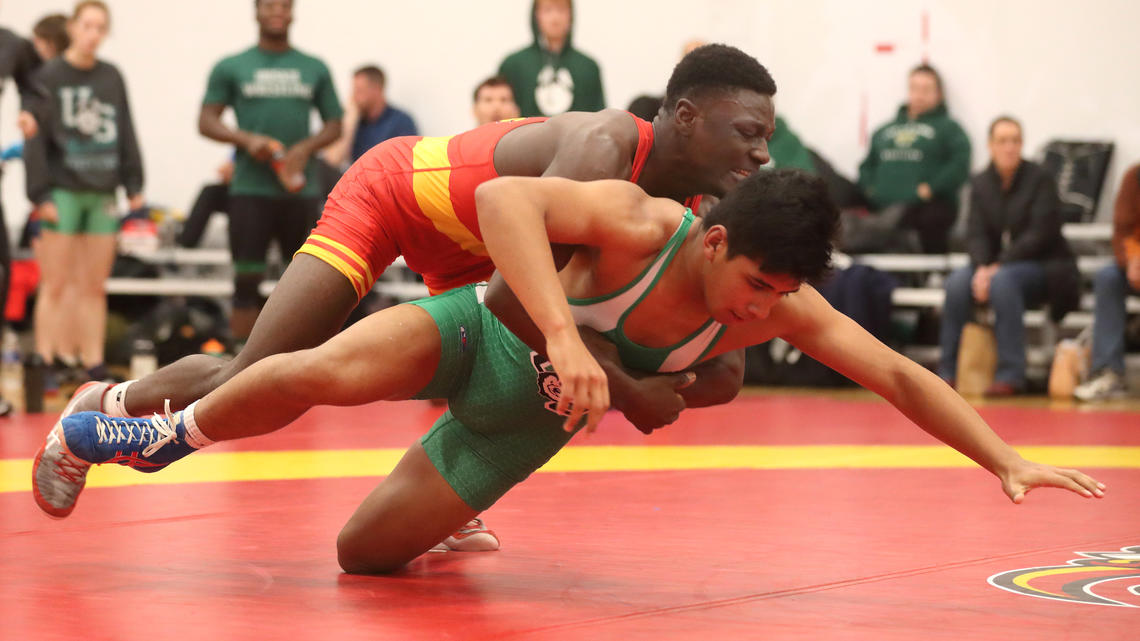 Emmanuel Olapade faces another opponent on the wrestling mat