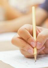 hands writing multiple choice exams