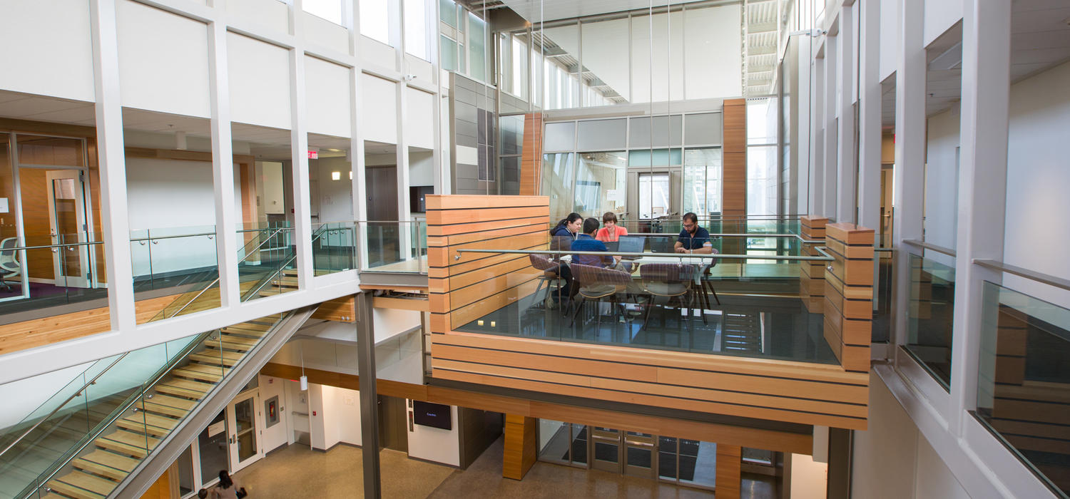 A series of hanging pods are suspended from the building’s spine, serving as informal meeting spaces, work areas, or places to relax. Photo by Riley Brandt, University of Calgary
