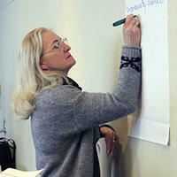 Person writing on whiteboard