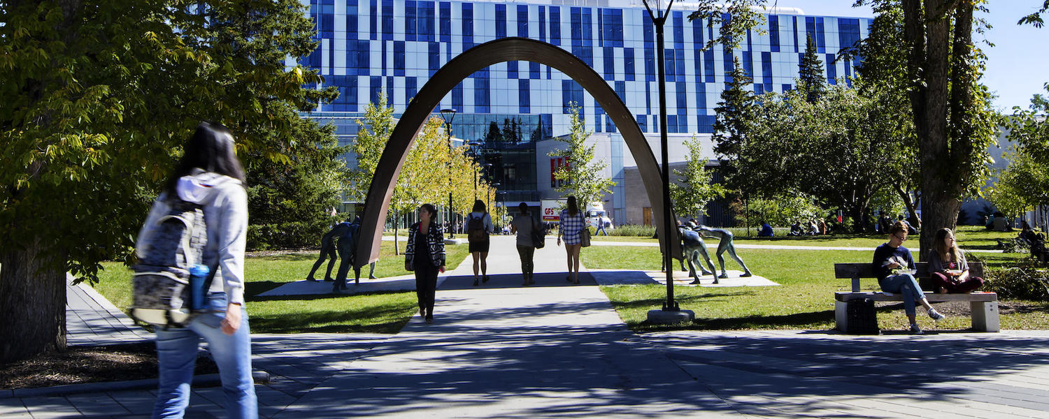 student walking across campus in the summer