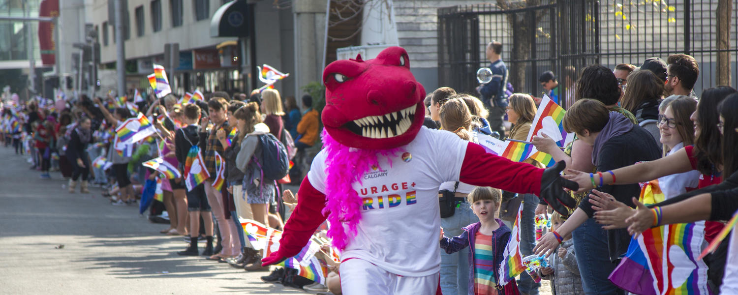 Rex, the red T-rex, wears a pink feather boa at the Calgary Pride parade