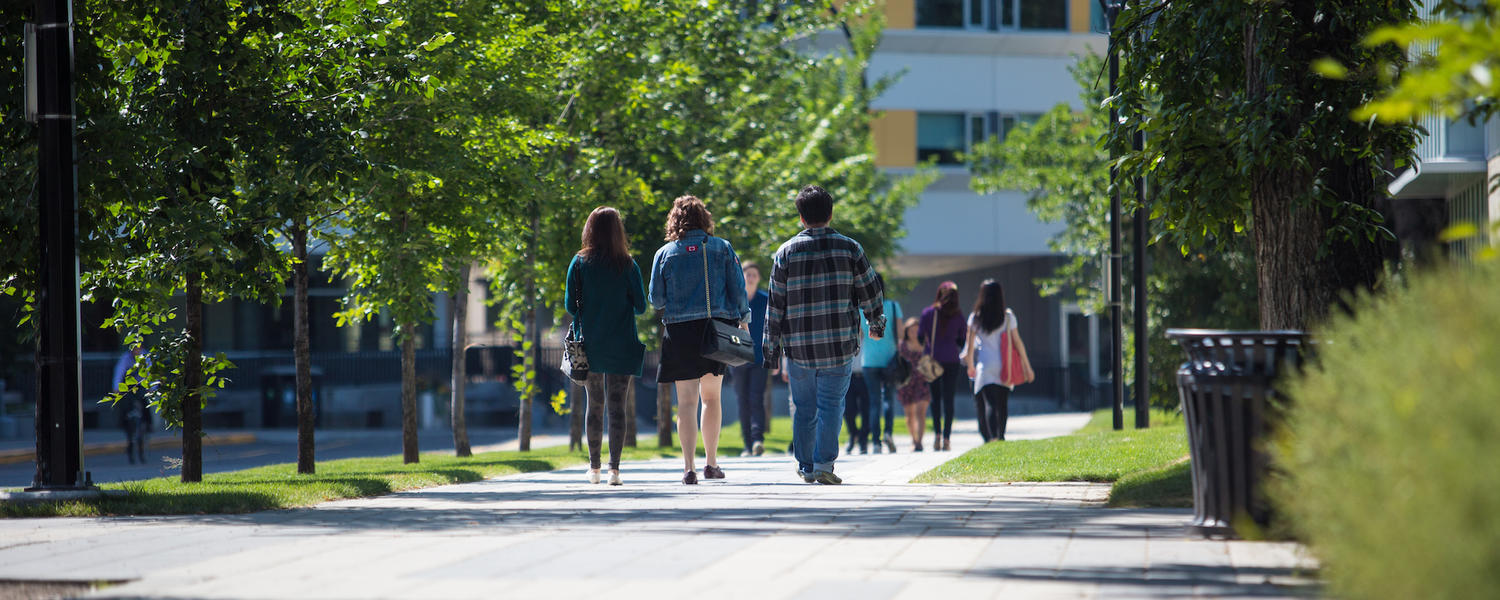 student walking across campus in the summer