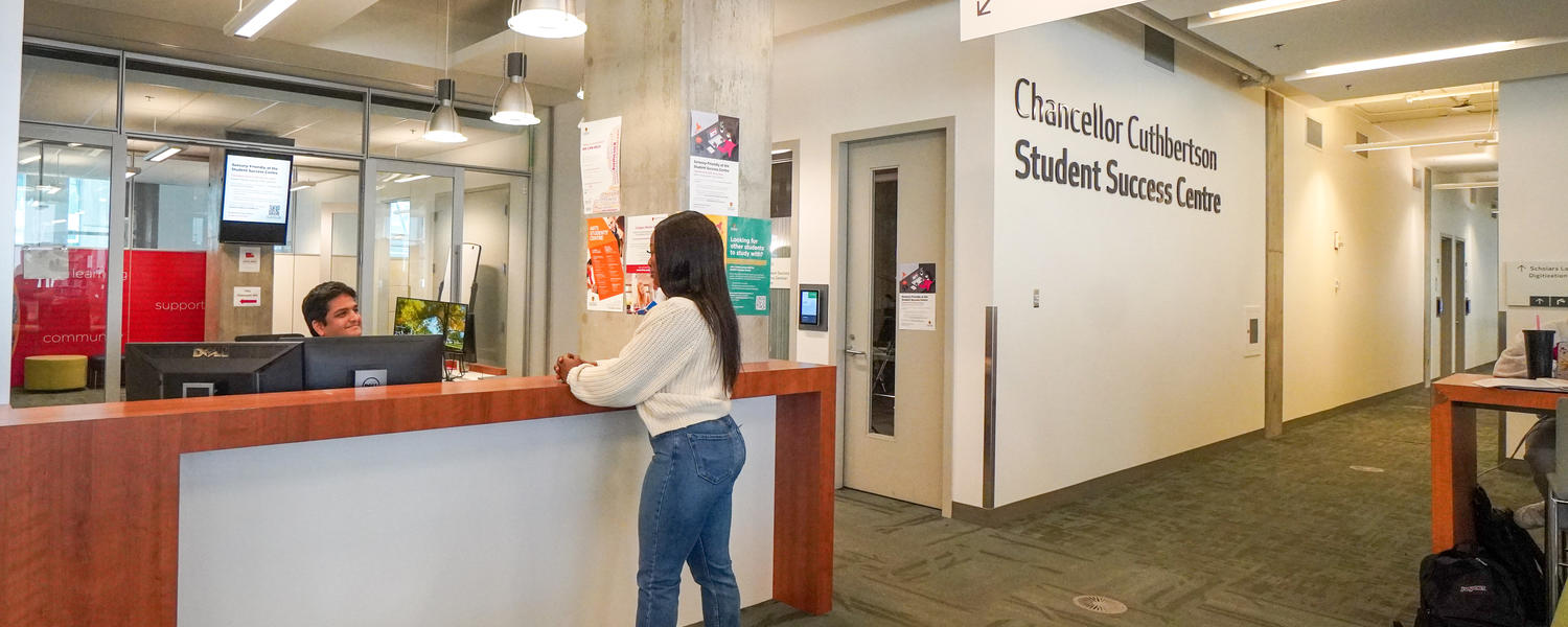 Student speaks to staff at Student Success Centre desk