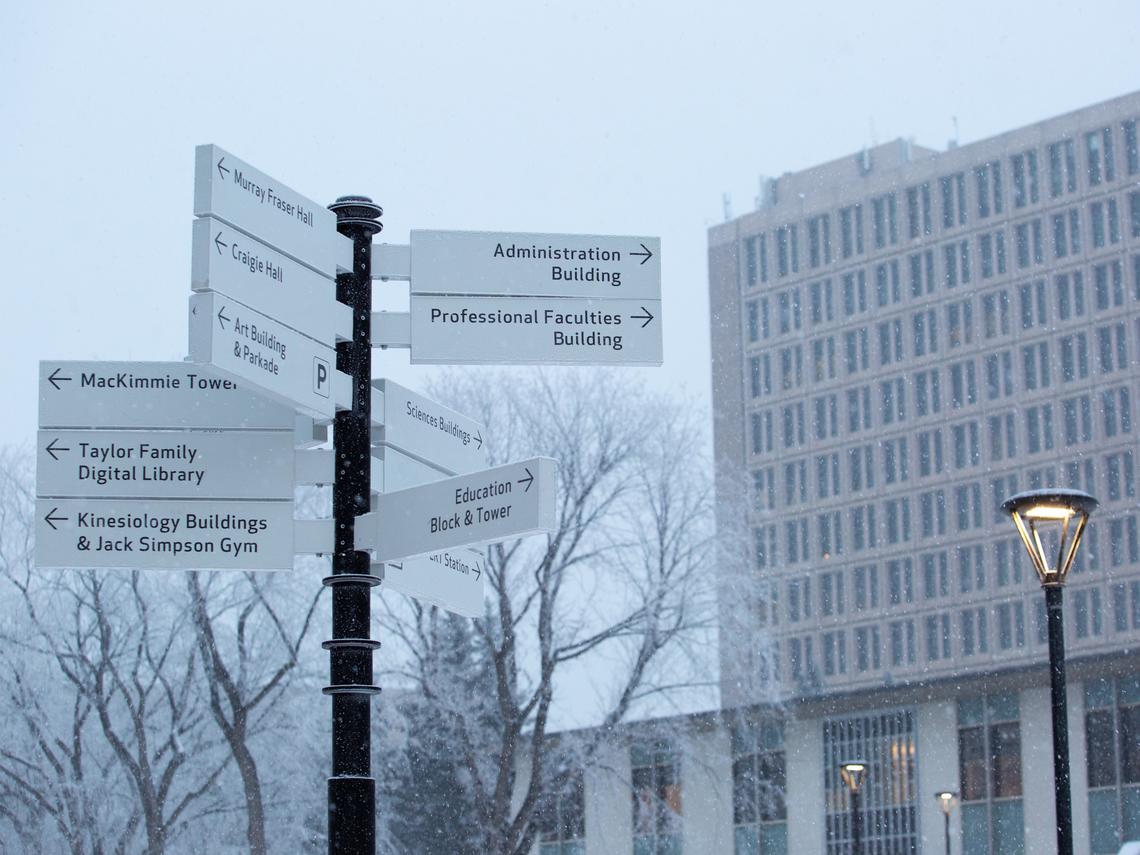 signage on a wintery main campus
