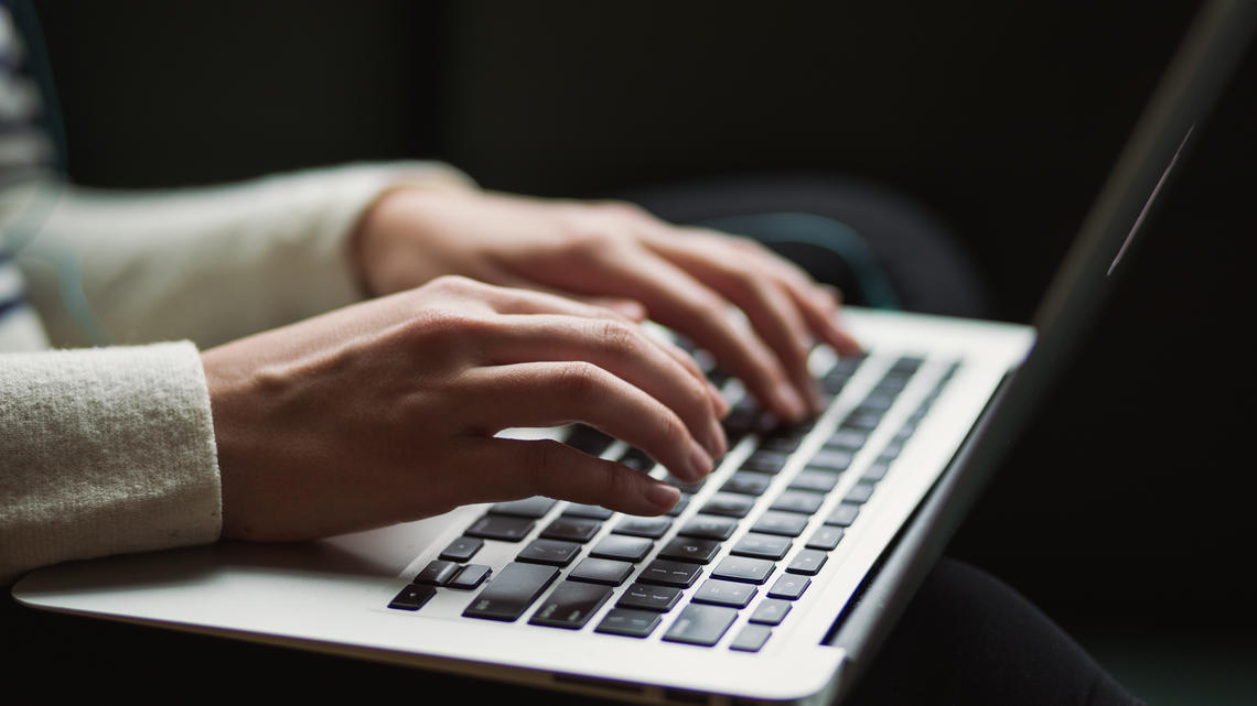 Person typing on their computer