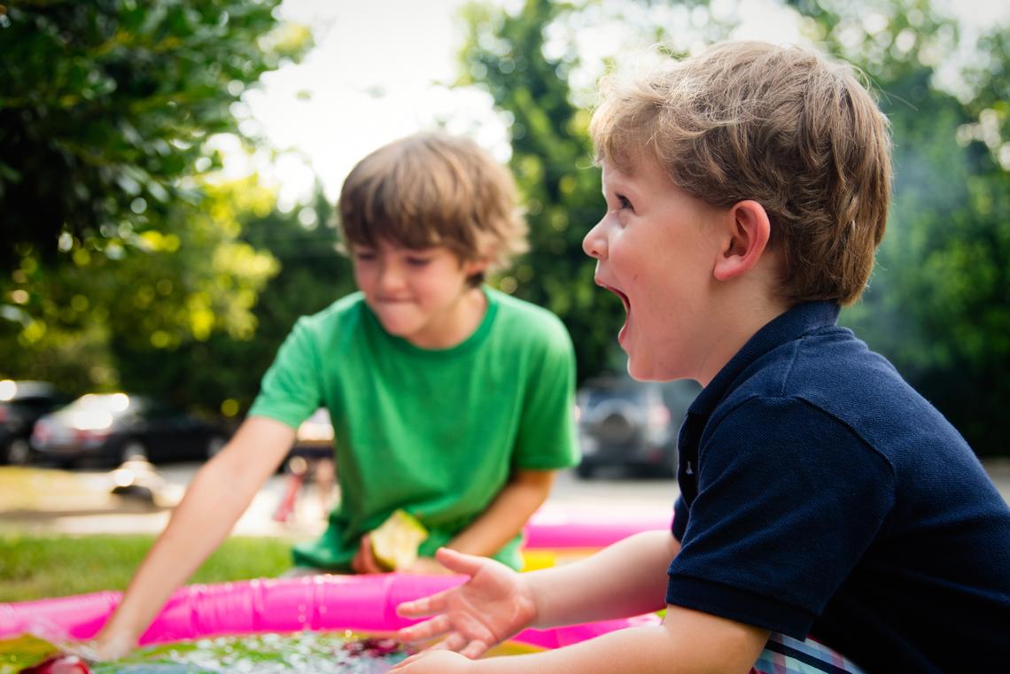 Two children are having laughing together outside