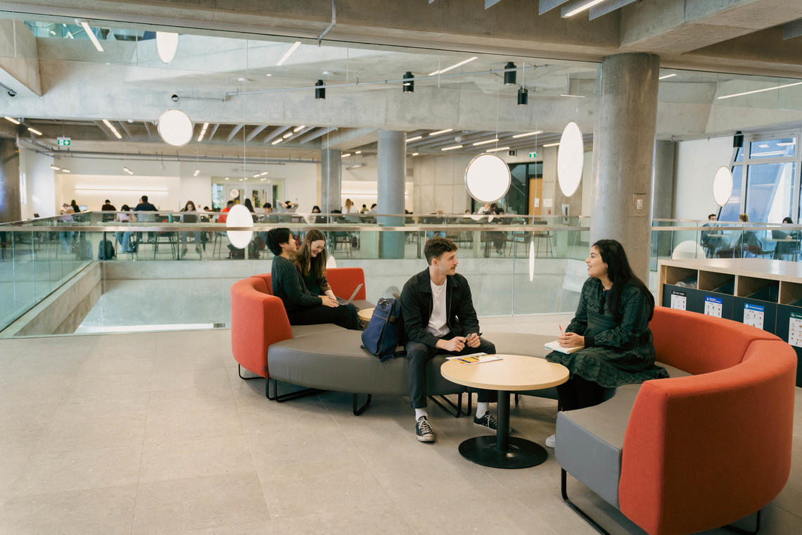 Students sitting on couches studying.