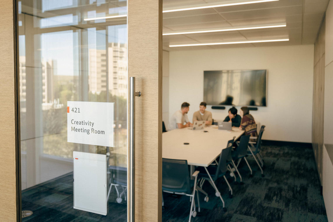 Students working together in meeting room.