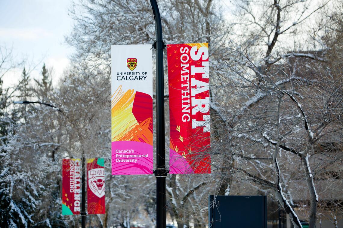 Photo of streetlight banners reading "Start Something" and "University of Calgary; Canada's Entrepreneurial University"