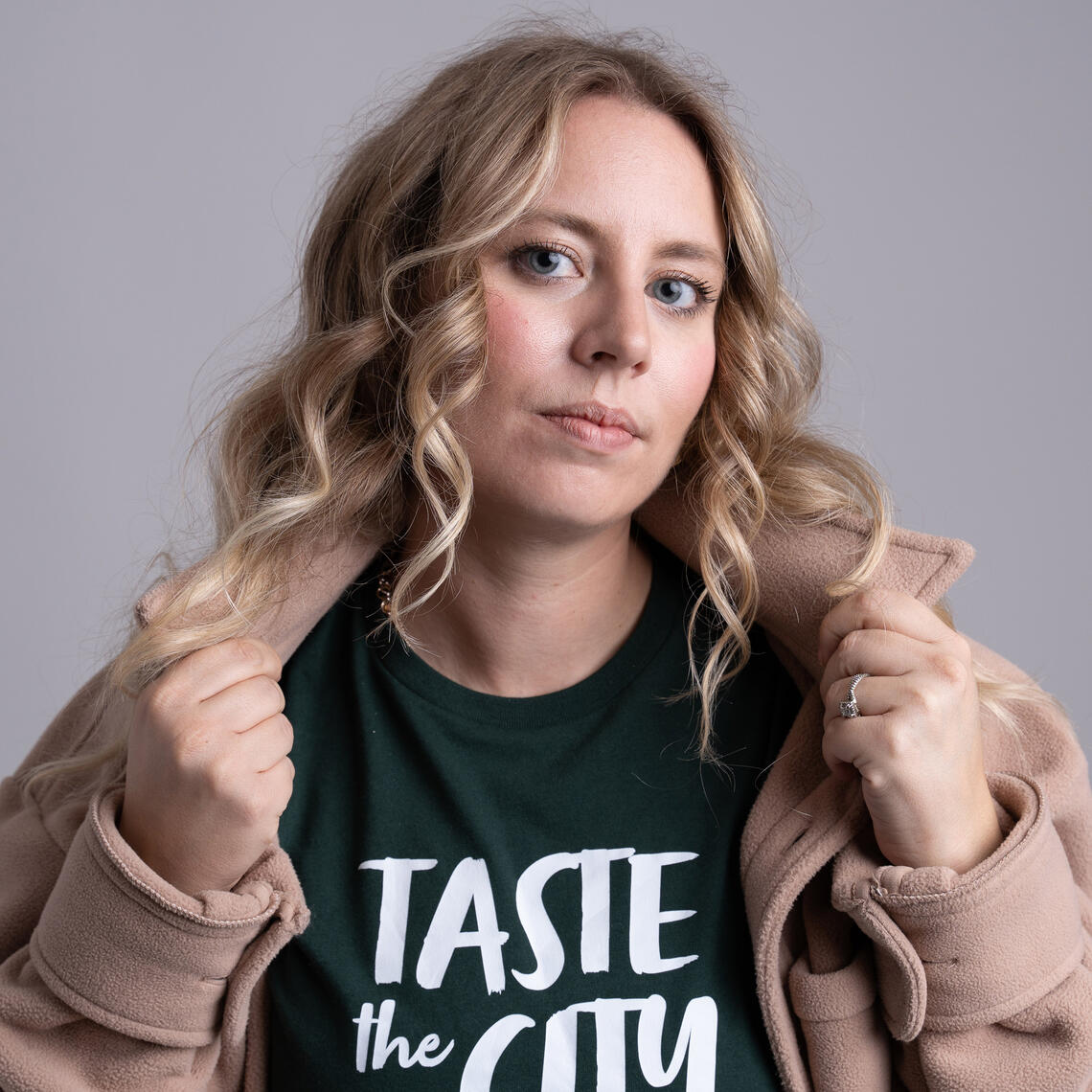 A woman wearing a shirt that says Taste the City