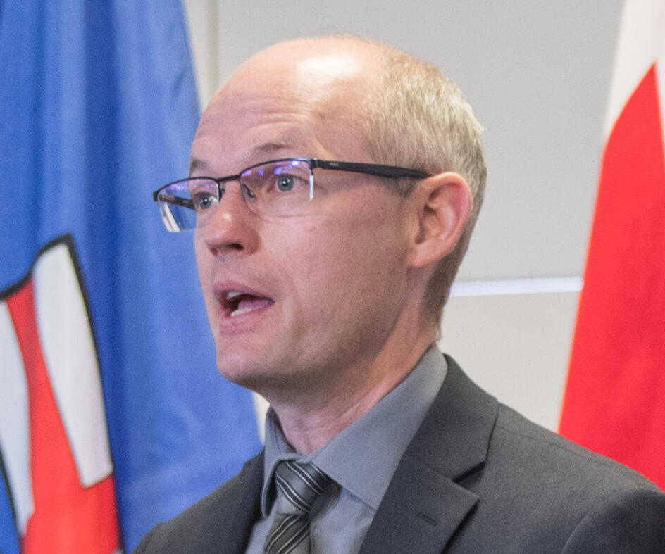 A man stands behind a podium giving a speech