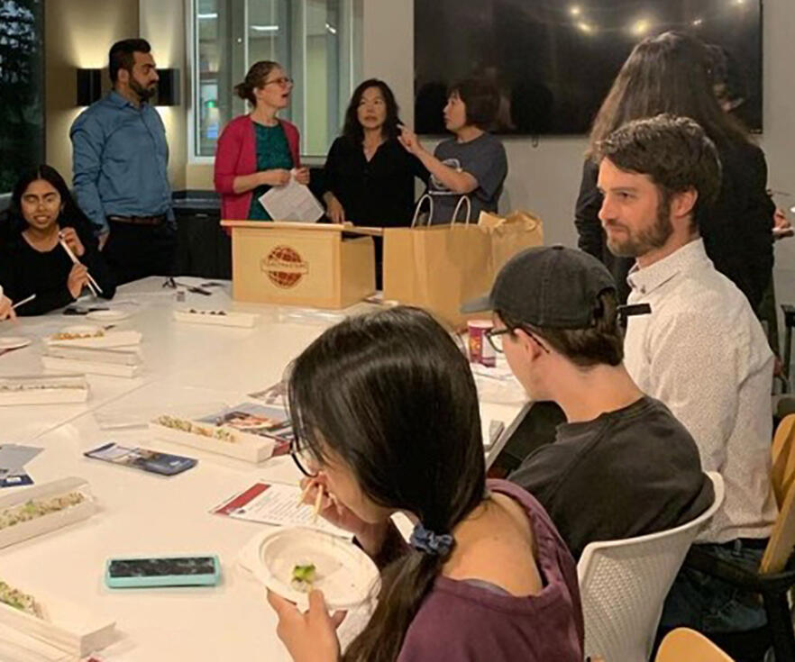 A group of people sit around a table