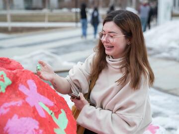 Newly admitted student painting The Rock at the annual You at UCalgary event.
