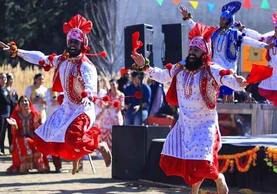 Photo of two men dancing in traditional clothing 