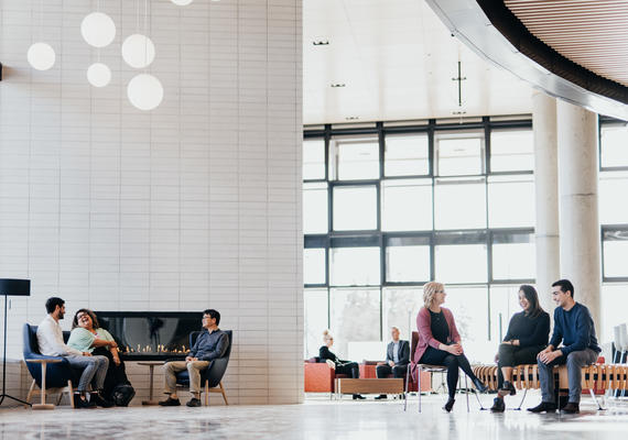 Individuals sitting in the Haskayne building