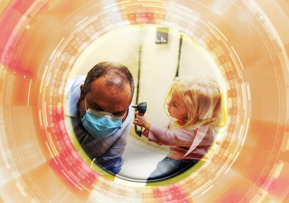 A child holding a medical tool to an individual's ear