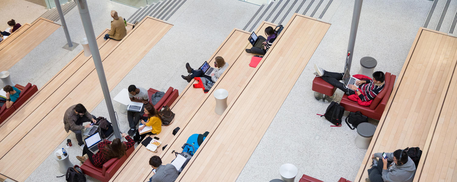 bird's eye view of students sitting on a concrete staircase