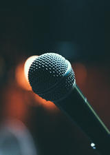A close-up shot of a microphone against a blurry background.