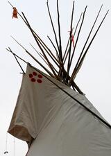 image of a teepee set against a clear sky