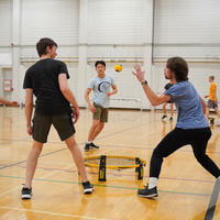 Students playing Spikeball in the gym