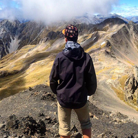A student overlooking a mountain while on a study abroad experience