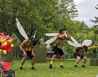 Wagonstage performers dressed as pollinators