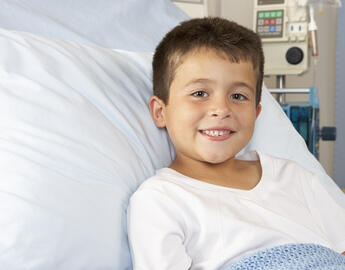 A child on a hospital bed. 
