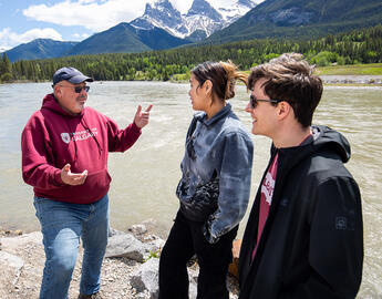 Staff and students next to a river