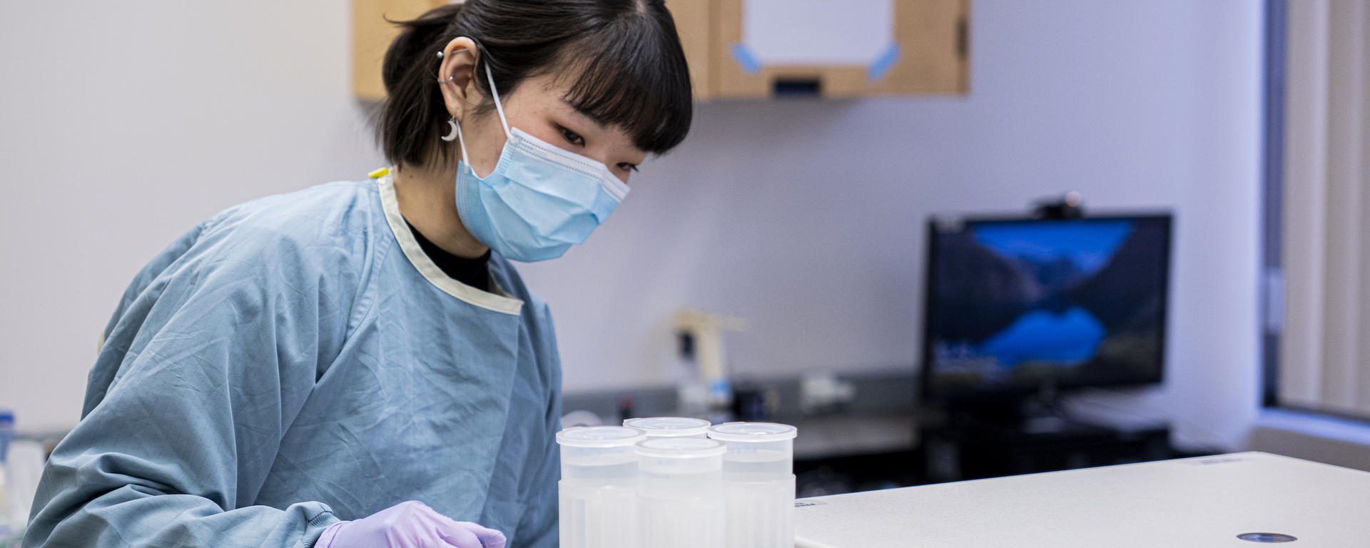 Researcher in Xiaoli Lilly Pang's lab at Alberta Precision Laboratories' public health lab.