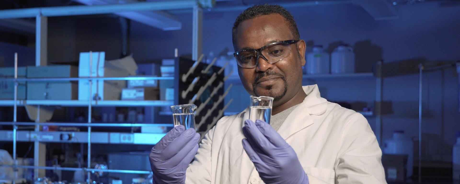 A man holding test tubes