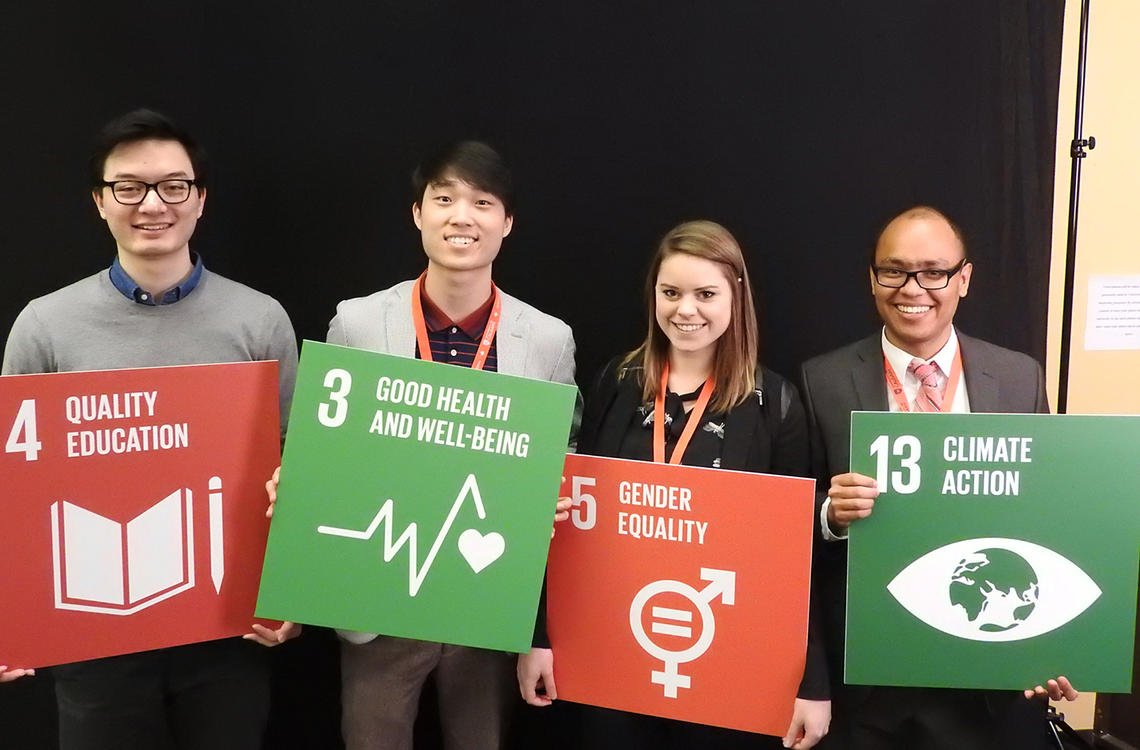 Event attendees hold Sustainable Development Goals at 2017 International Development Week. University of Calgary International photo
