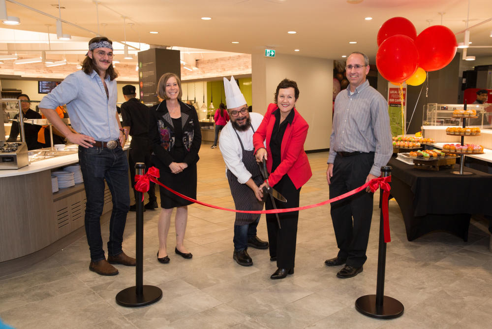 Reece Vandersanden, Residence Students' Association president; Linda Dalgetty, finance and services vice-president; Chef Paul; Jill Blackie, food and conference services associate director; and Shane Royal, Ancillary Services director, make the opening of The Landing official on Sept. 27 with a short ribbon-cutting ceremony followed by treats, games and prizes for students.