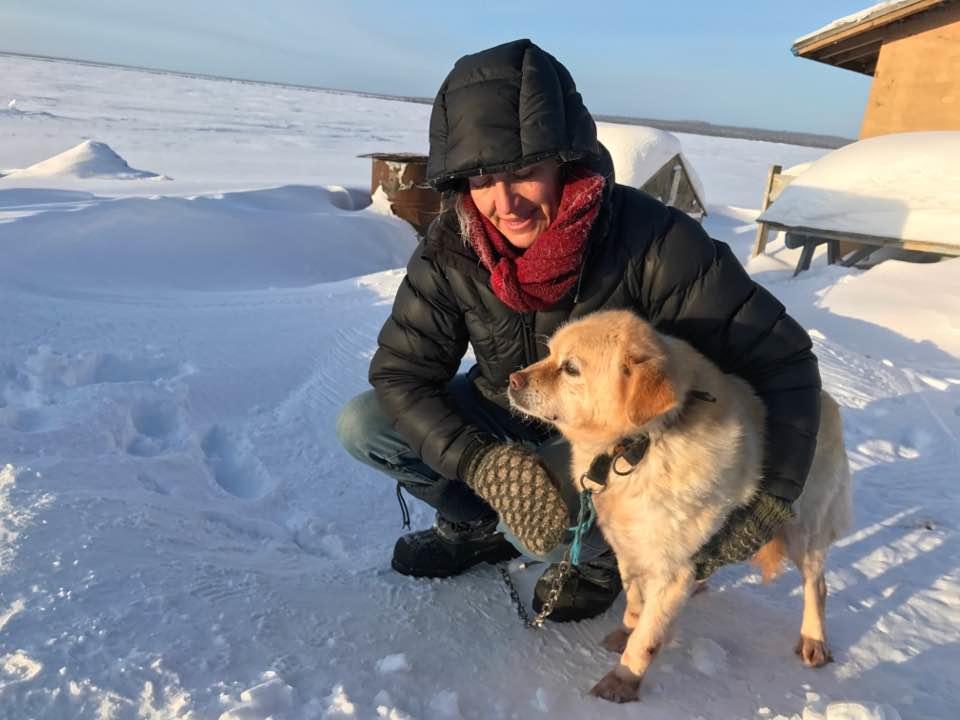 Susan Kutz in the Sahtu settlement region near Norman Wells in the Northwest Territories with a dog during a veterinarian clinic.