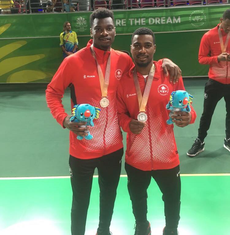 University of Calgary student-athletes Mambi Diawara, left, and David Kapinga pose after winning silver medals in the men's basketball final at the 2018 Commonwealth Games.