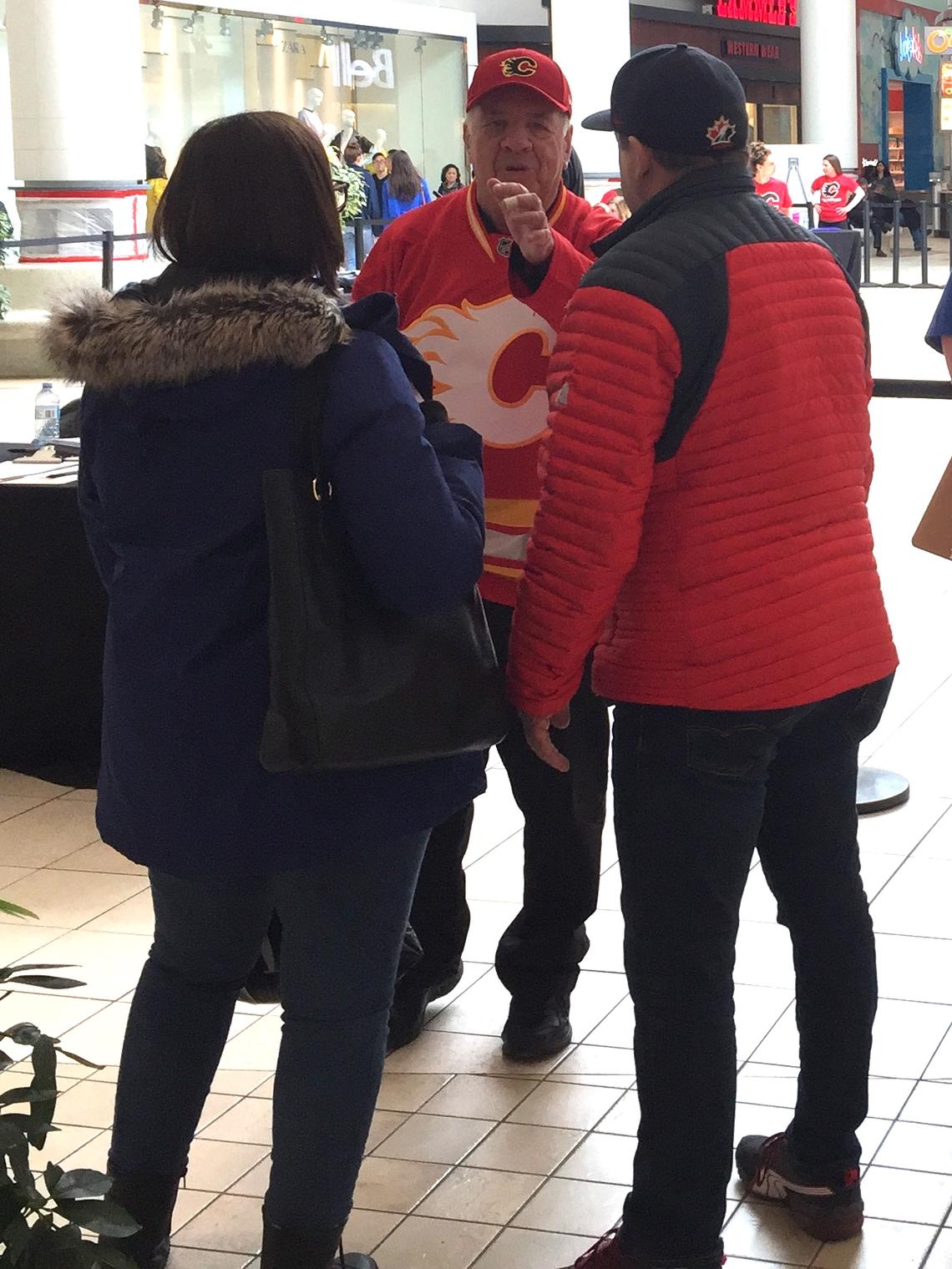 Shoppers chat with legendary sportscaster Peter Maher, the voice of the Flames from 1980 until his retirement in 2014, at Chinook Centre, one of two Calgary-area locations that hosted this year's Flames Health Training Camp.