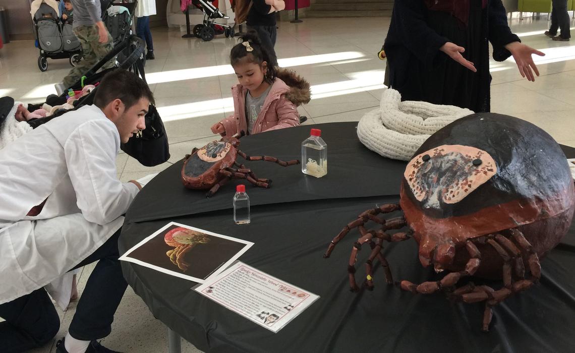 Host-Parasite Interactions' Adam Shute talks about ticks and parasitic worms with a fearless youngster.