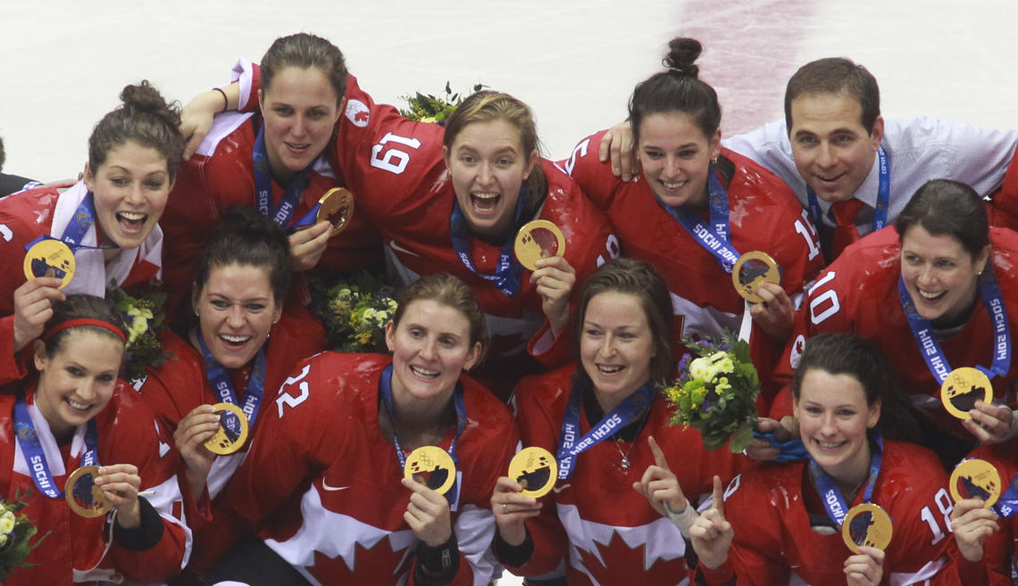 Brianne Jenner, top row, number 19, celebrates gold with her teammates at the Sochi Olympics in 2014. 