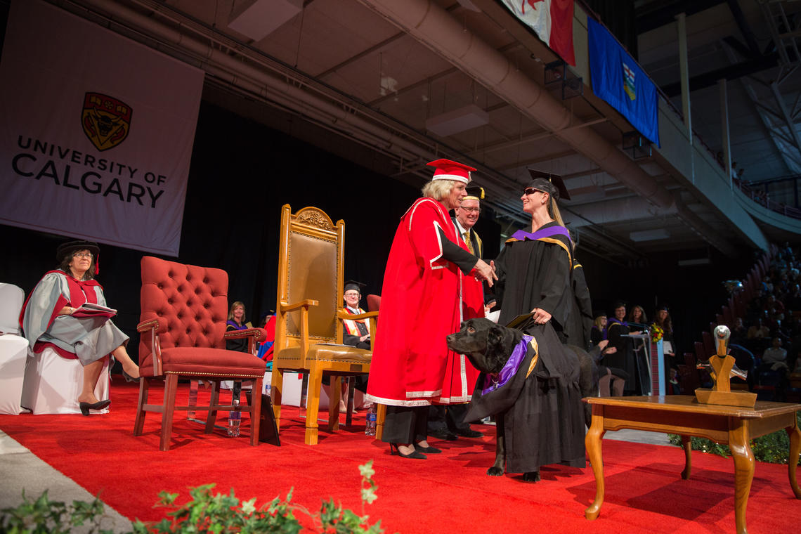 University of Calgary President Elizabeth Cannon congratulates Tiana Knight and Cashmere during the convocation ceremony on Monday. Photo by