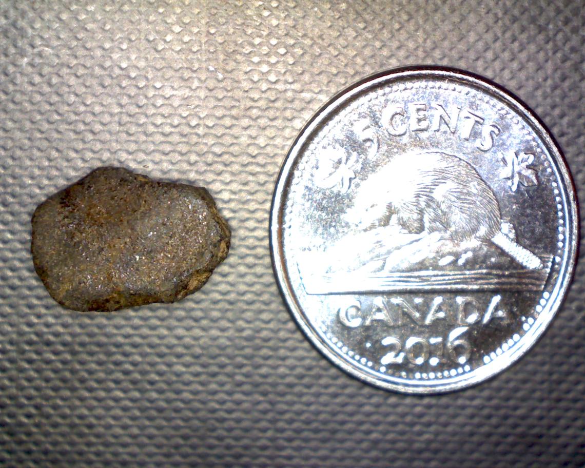 Comparison of a remnant beside a nickle.
