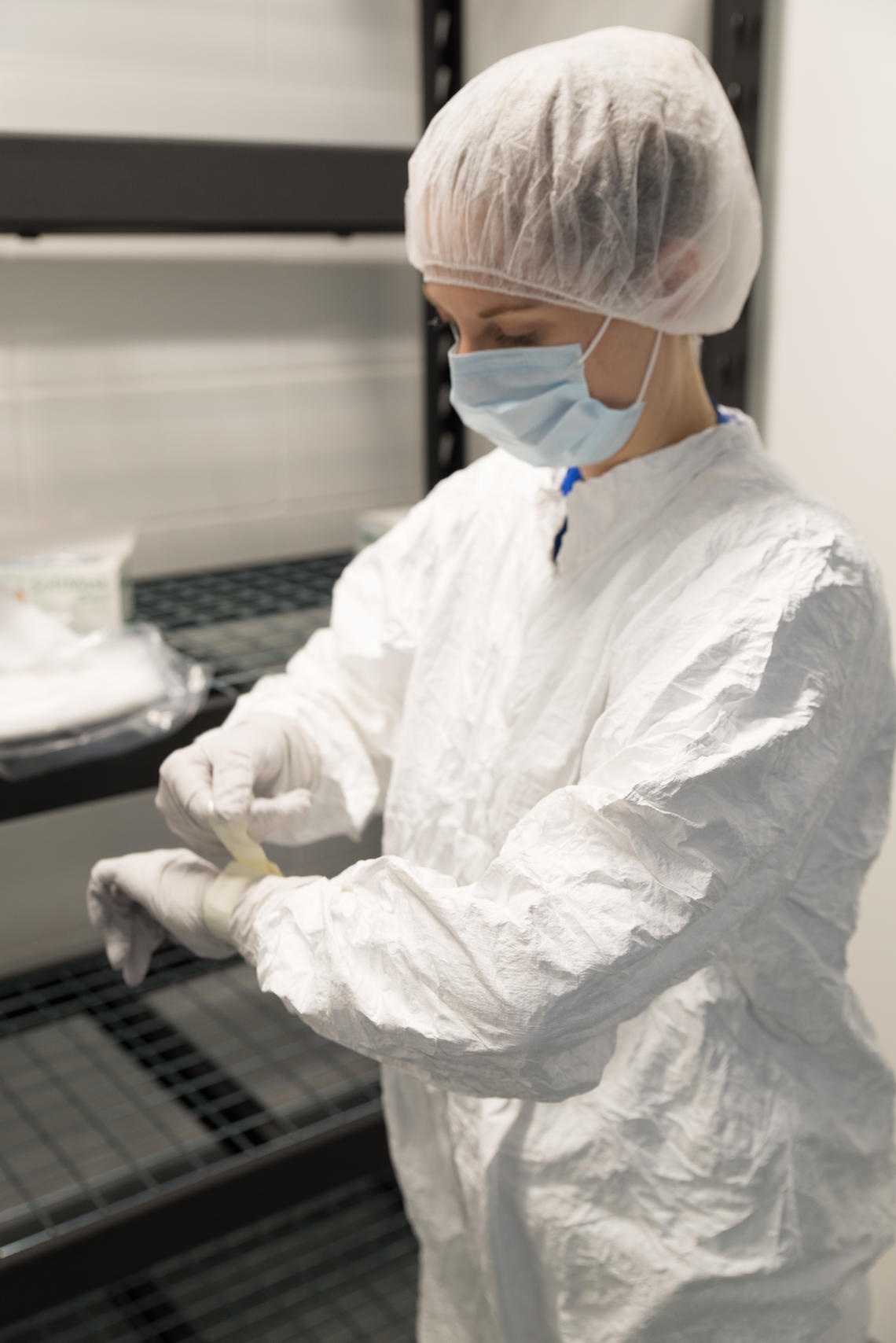 Your outfit includes a Tyvek suit, gloves, mask, hair net, and clogs at the International Microbiome Centre.