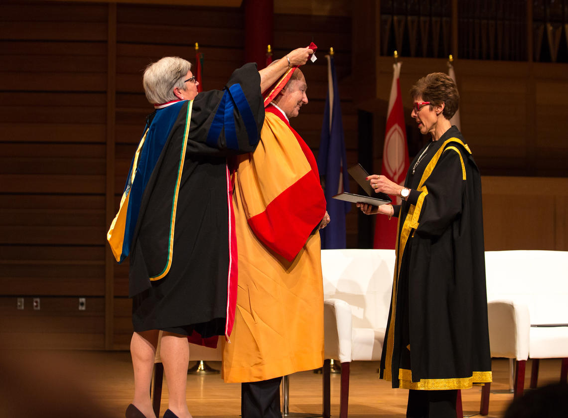 University of Calgary Provost Dru Marshall, left, and Chancellor Deborah Yedlin lead a hooding ceremony conferring an honorary degree on His Highness the Aga Khan. 