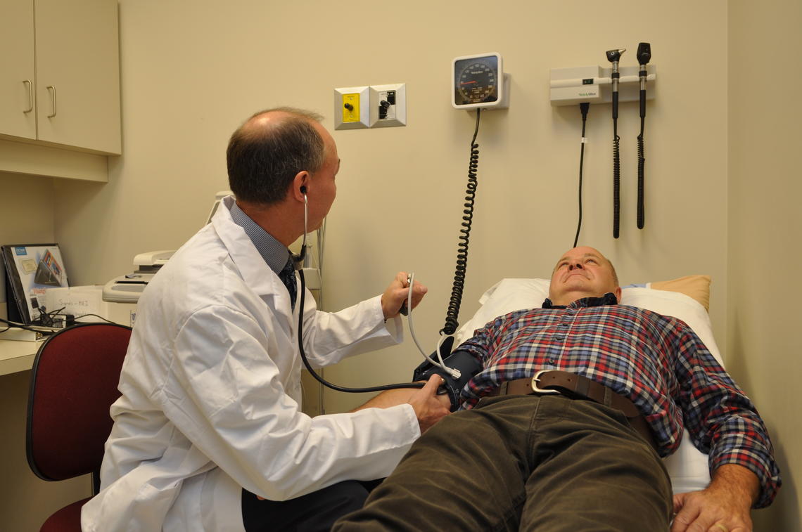 Dr. Todd Anderson checks the blood pressure of a patient. Nearly one-third of Canadians have high cholesterol.