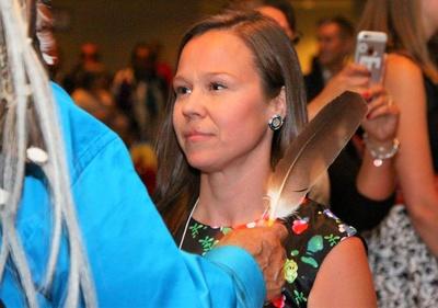 Vicki Bouvier gifted an eagle feather from Piikani Elder Reg Crowshoe at the Native Centre Aboriginal Graduation ceremony in June 2016.