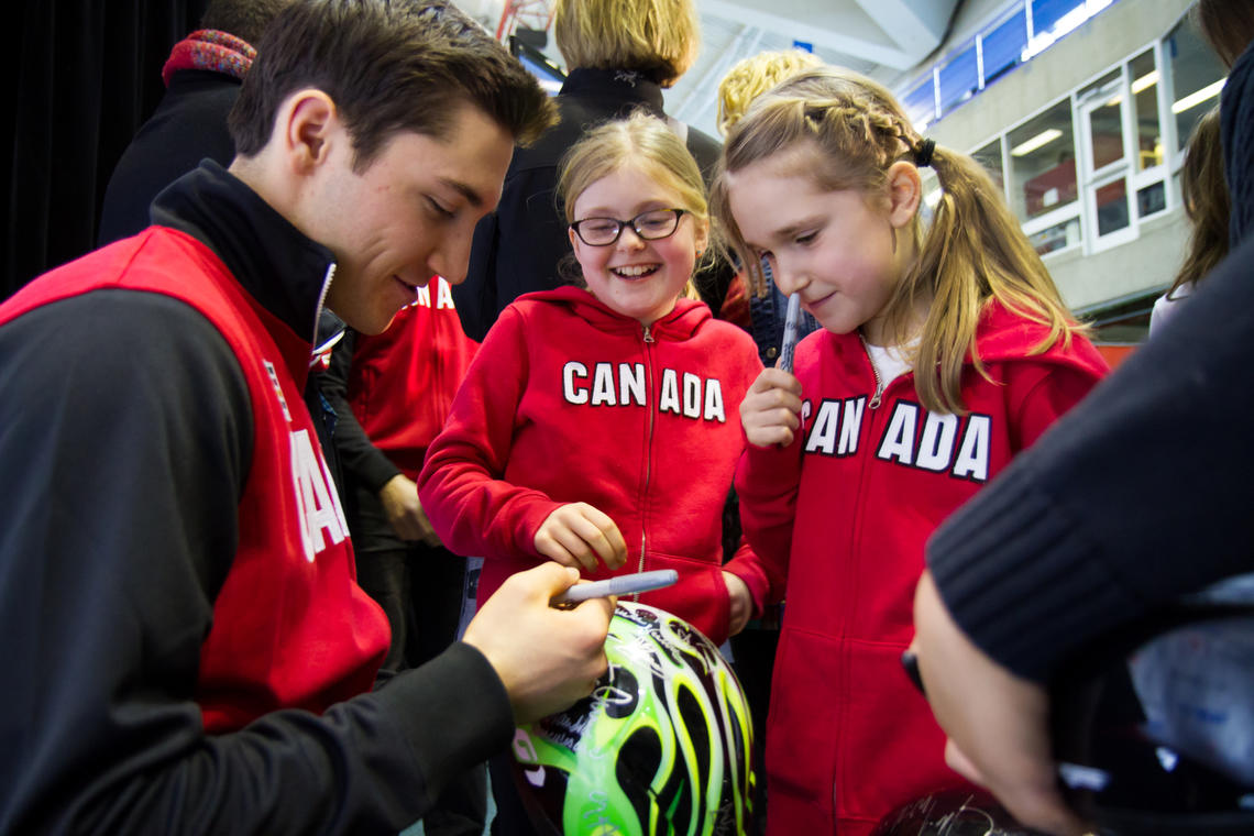 Vincent De Haître of Cumberland, Ont.—one of the eight men announced as members of the long track Canadian Olympic Speed Skating Team—signs autographs at the Oval.