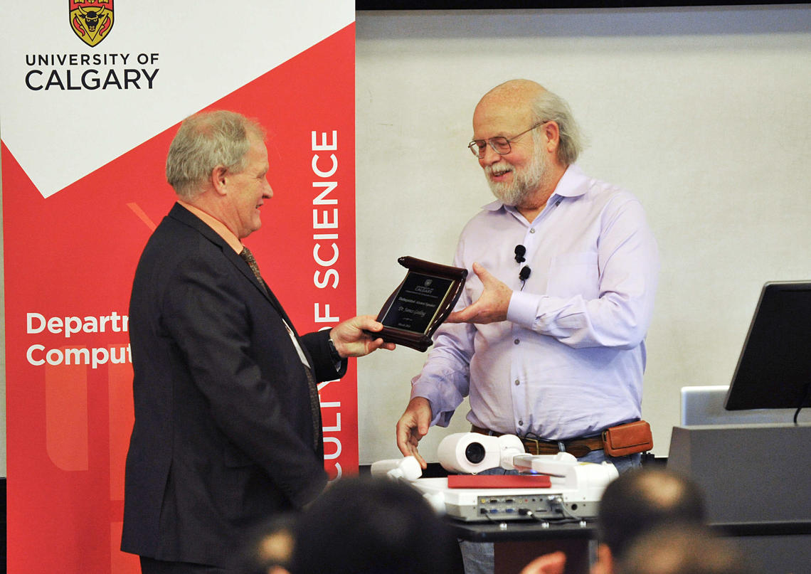 Ken Barker, dean of the Faculty of Science, presents James Gosling with the Distinguished Alumni Award from the Department of Computer Science.