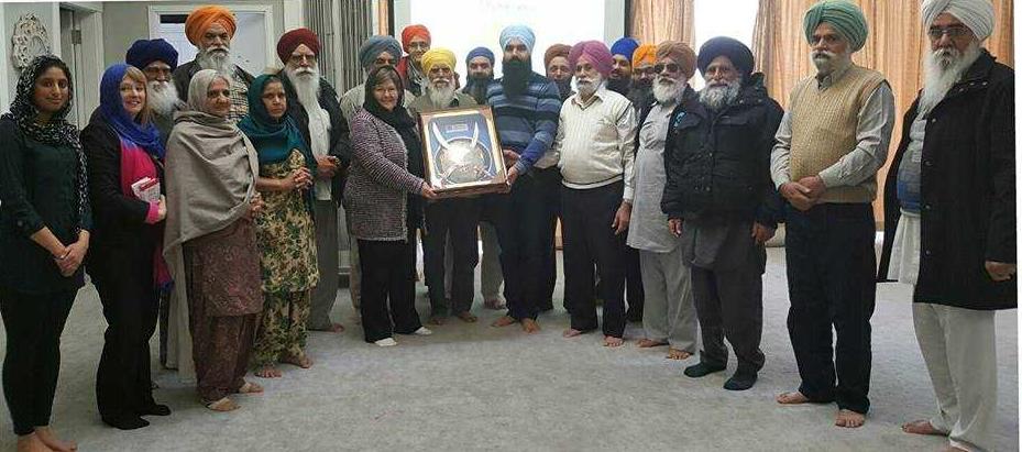 Kathryn King-Shier receives a gift from people at the Dashmesh Culture Centre following a presentation on her research.