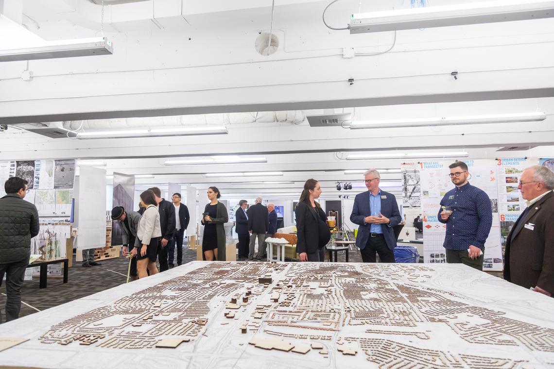 Robyn Erhardt, centre, shares a thought with instructor Douglas Leighton at the School of Architecture, Planning and Landscape Year-End Show 2019. Photo by Neil Zeller, for the School of Architecture, Planning and Landscape