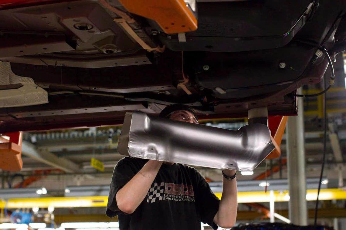 Due to global supply chains, U.S. automakers are as aghast at Trump’s tariffs threats as any pro-free traders. An assembly line worker at the General Motors Assembly plant in Oshawa works on a car in December 2011.